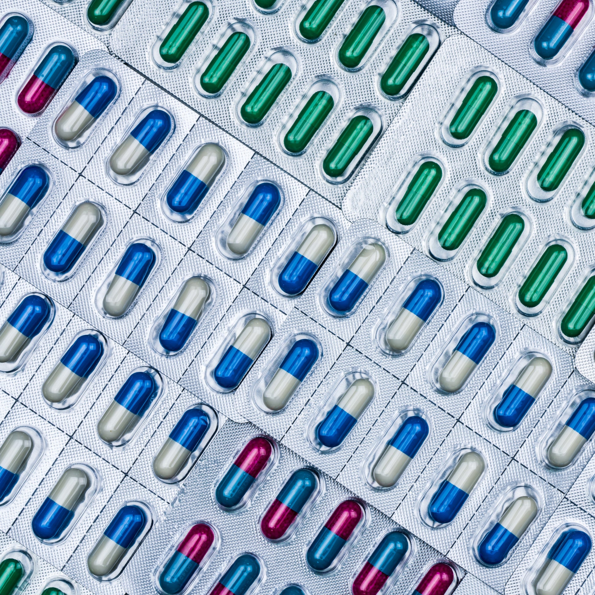 <Examples of foil blisters of blue and white or green dietary supplement capsules returned as faulty, lined up for examination and disposition . decision. Credit> AdobeStock_195624424