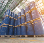 <Over twenty wooden pallets each with four 200 Kg blue metal drums containing materials for drug products received by the warehouse and stacked three high. Credit> AdobeStock_224567290