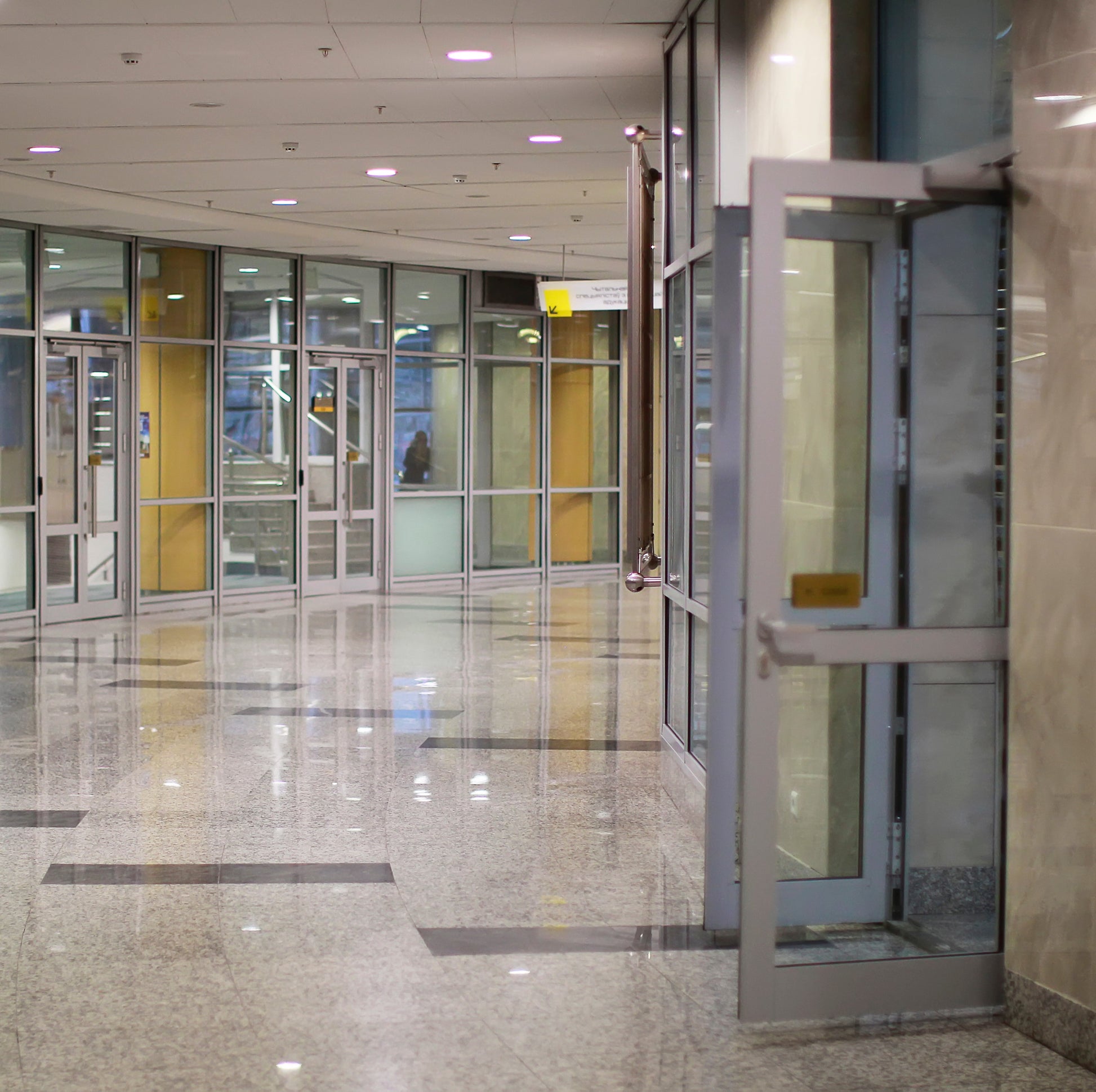 <Polished marble floor and wall lobby of the entrance to a drug facility via glass doors. Credit> AdobeStock_297383102