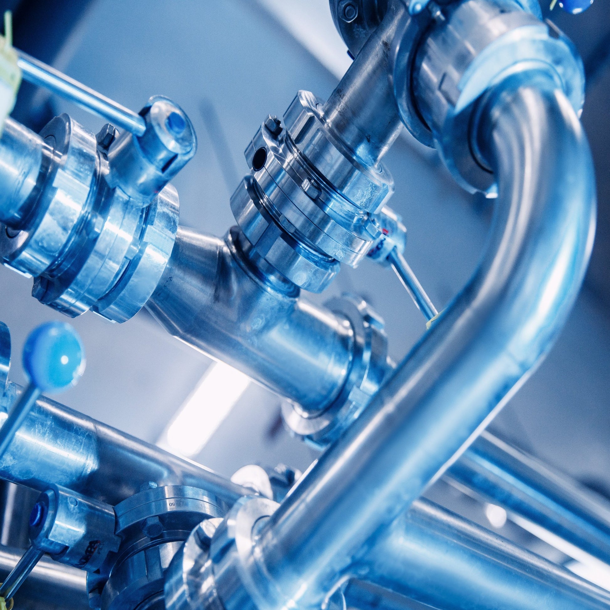 <Stainless steel pipework, valves and connectors used to convey and transport dietary supplement liquids and gels. Credit> AdobeStock_388675579