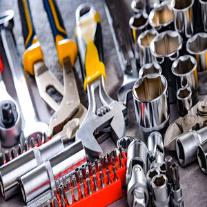 <Maintenance Engineers tools including chrome socket spanner set, various screwdriver heads in an orange block, and socket wrench. Credit> AdobeStock_461988008