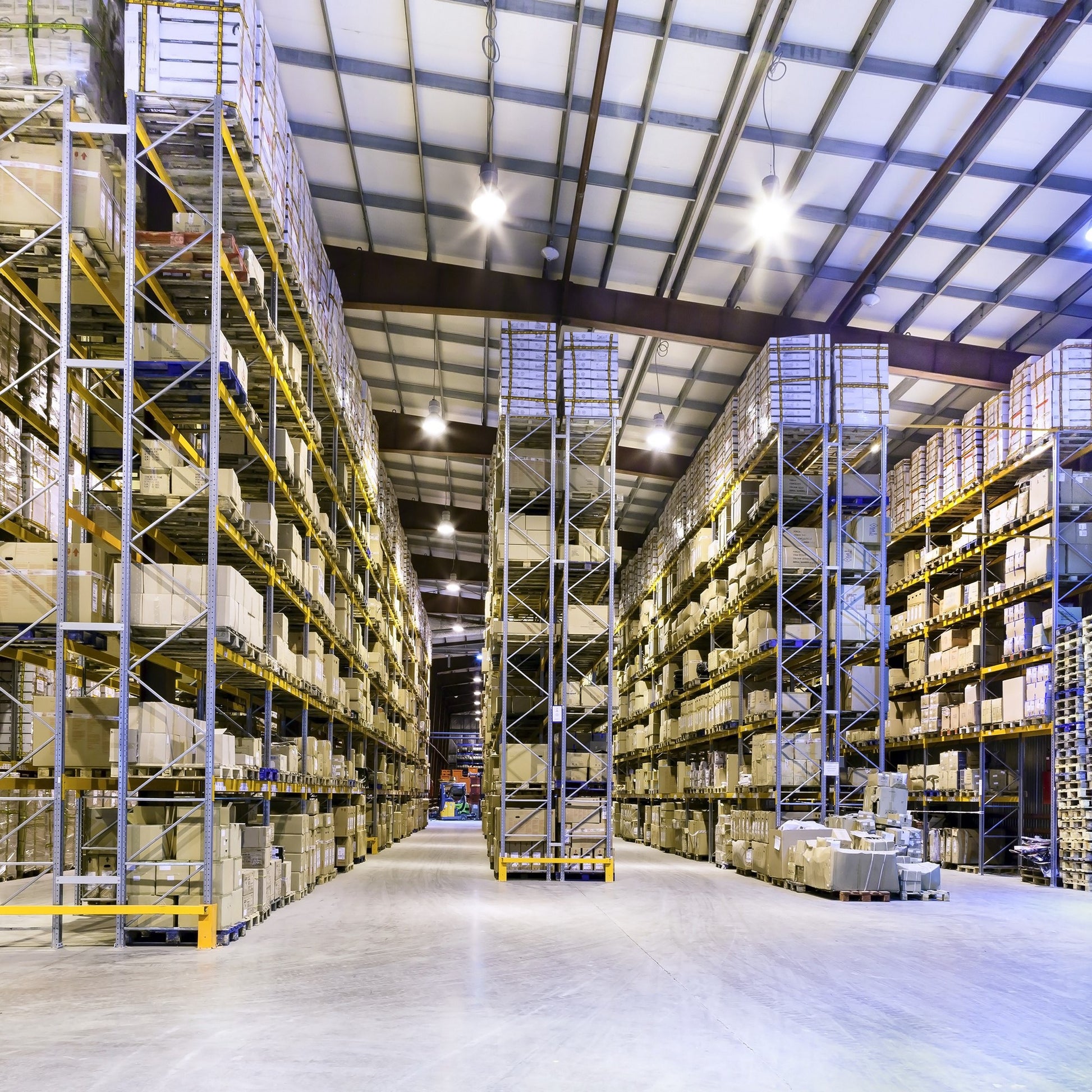 <Large, clean, tidy warehouse with high racking storing outsourced customer drug product. Credit> AdobeStock_51465184