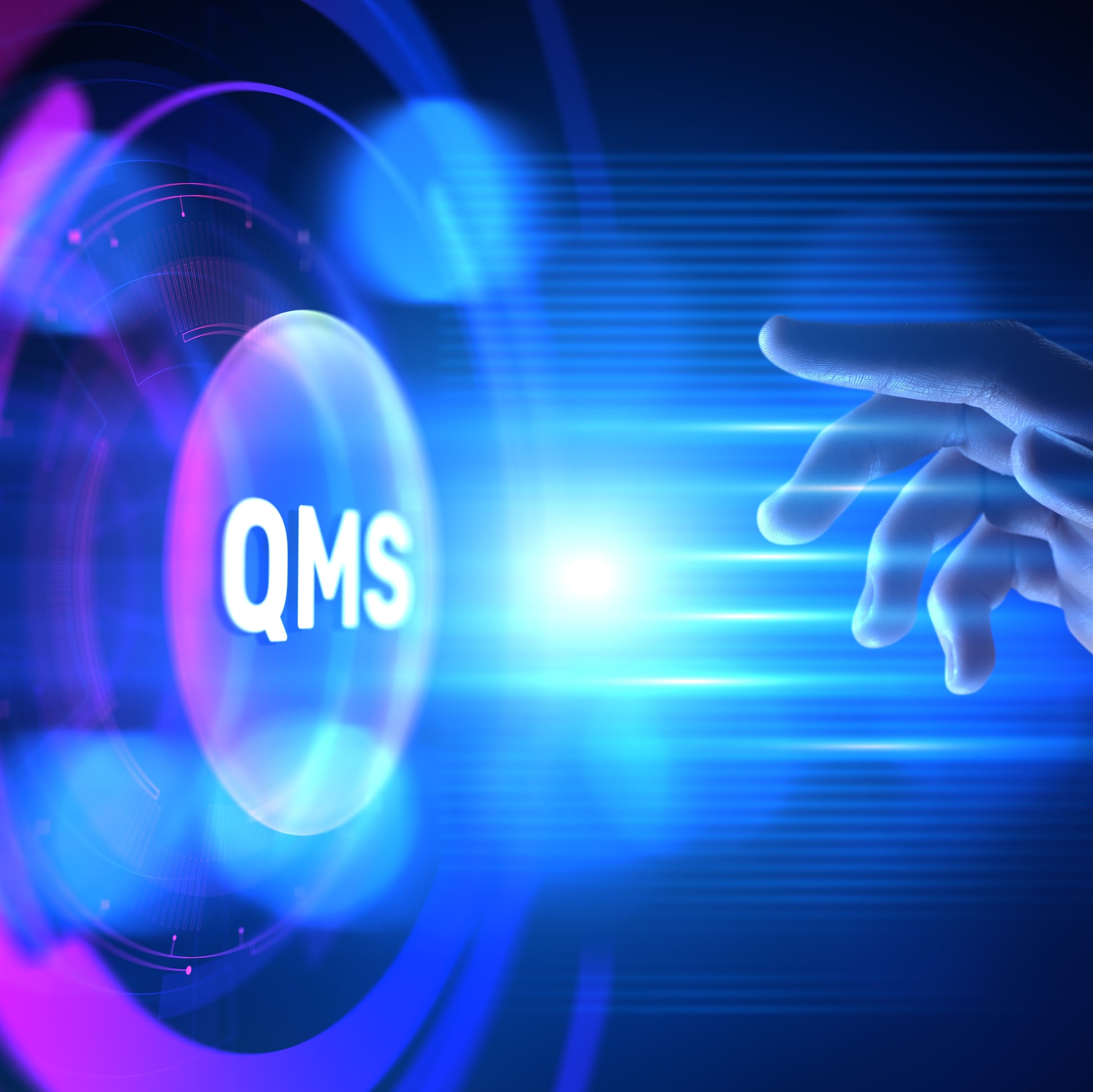 <Hand reaching to press a big button labelled QMS in the middle of a round, futuristic, blue lit virtual screen. Credit> 345437757 Kseniia Kolesnikova | Dreamstime.com